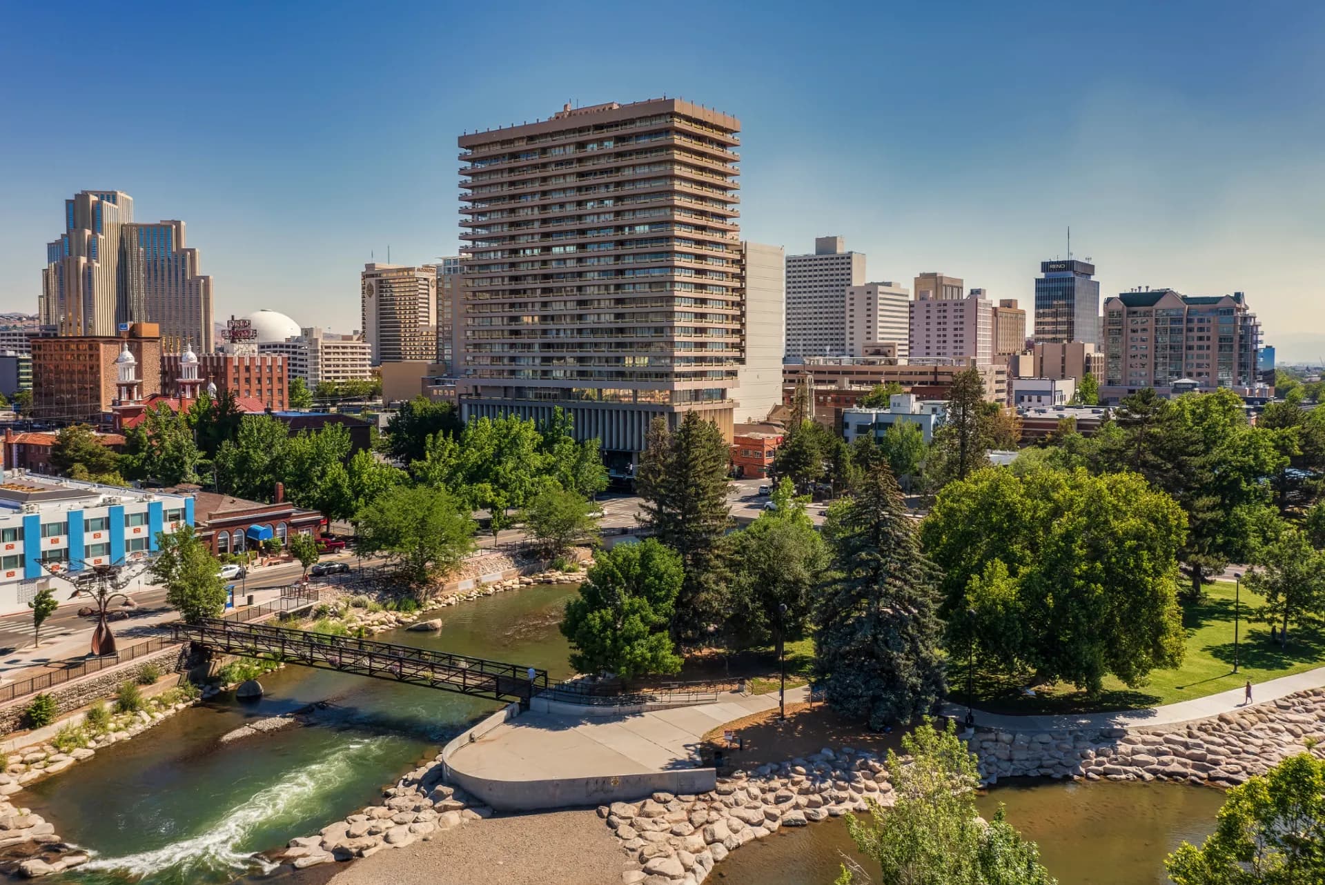The Truckee River whitewater park and downtown Reno skyline — Duvoire short-term rental management