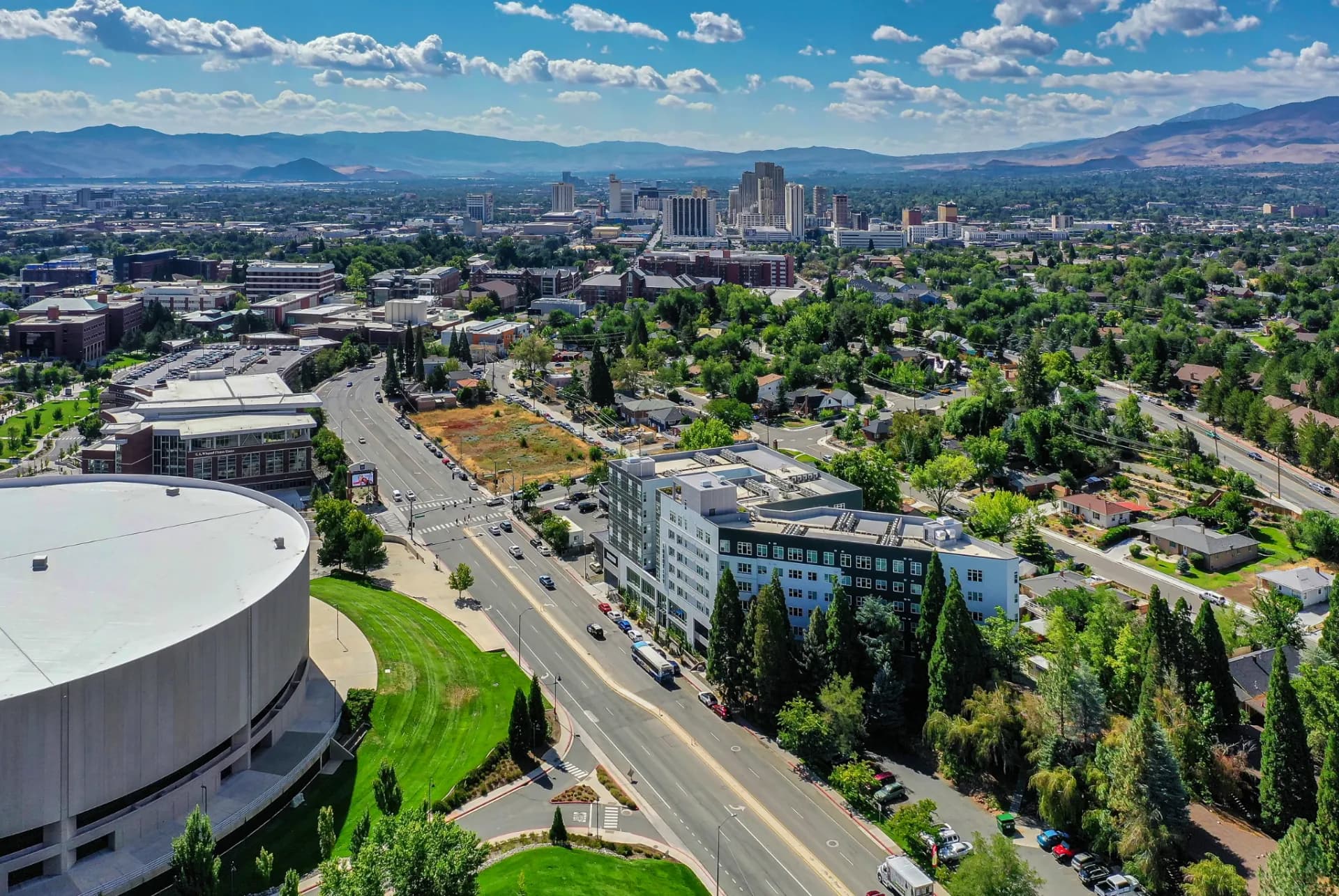 Aerial view over the University of Nevada, Reno campus toward downtown — the district where furnished mid-term stays cluster